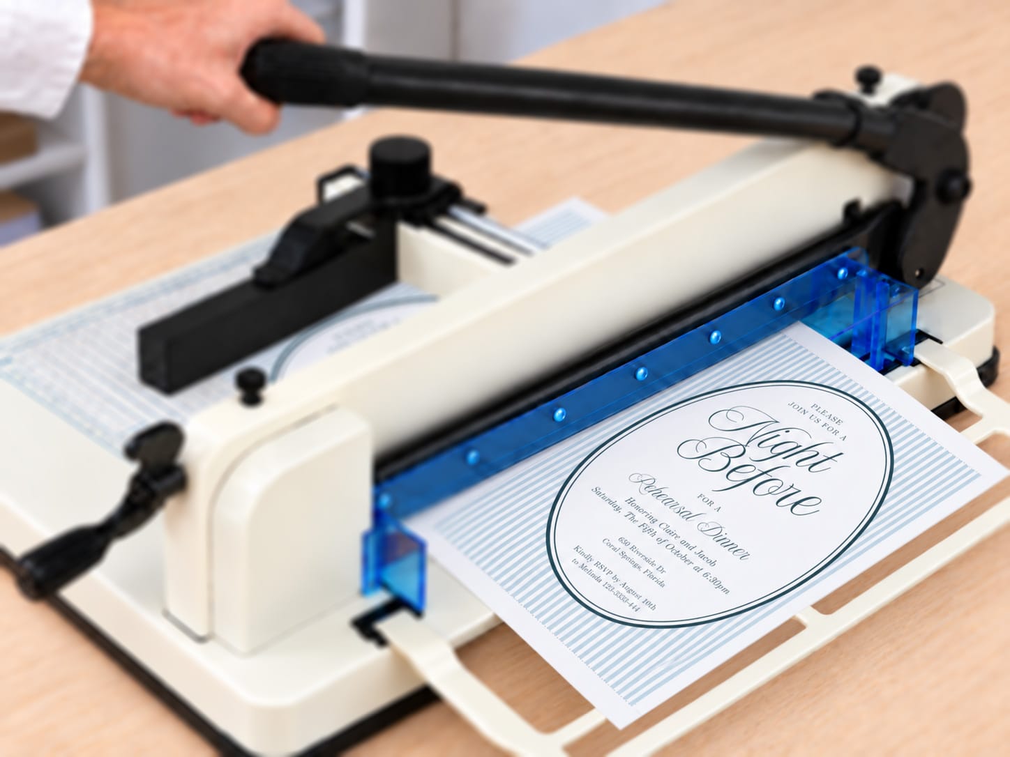 Supplied illustration of the striped invitation sheet on a guillotine cutter