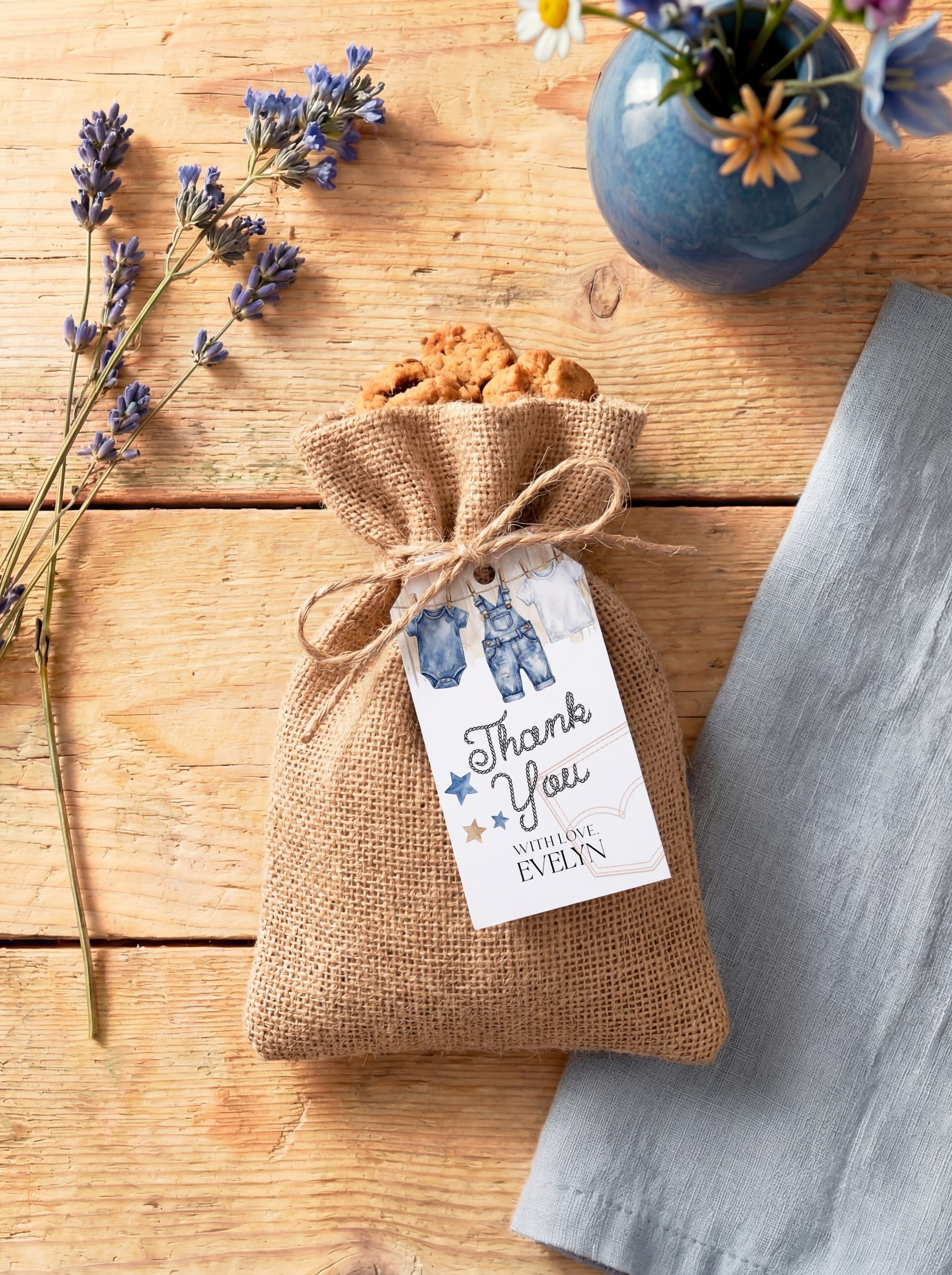 Mockup of the blue baby-shower thank-you tag attached to a favor bag