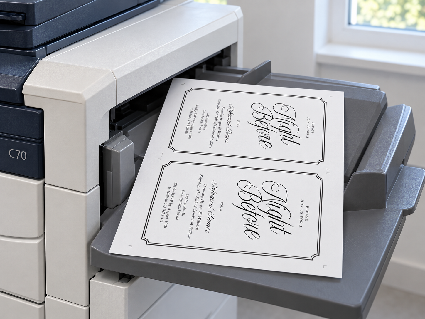Illustration of a two-invitation sheet resting in a printer output tray